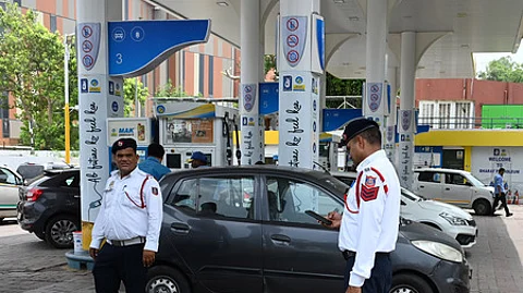 Traffic Police personnel keep a vigil at a petrol pump after fuel ban for end-of-life vehicles under the directions of Commission for Air Qua