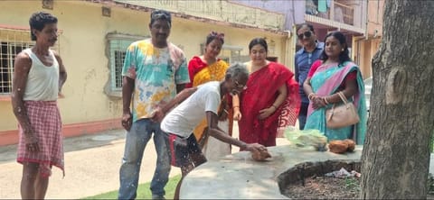 नारियल तोड़कर निर्माण कार्य का शुभारंभ करता दिहाड़ी मजदूर