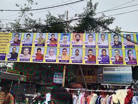 Members of Vidhan Market Businessmen Committee putting up posters