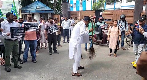 BJP workers cleaning with brooms