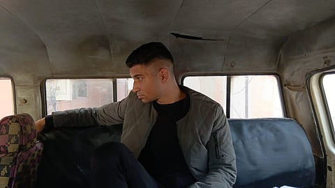 accused seated in police van