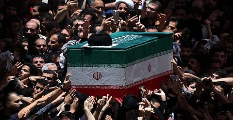 Grieving people bidding a final farewell by touching Khamenei's funeral bier