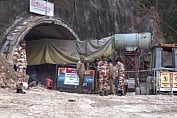**EDS: VIDEO GRAB** Uttarkashi: Security personnel outside the under-construction tunnel between Silkyara and Dandalgaon on the Brahmakhal-Yamunotri national highway, days after it collapsed trapping several workers inside, in Uttarkashi district, Thursday, Nov. 16, 2023. (PTI Photo)(PTI11_16_2023_000063B)