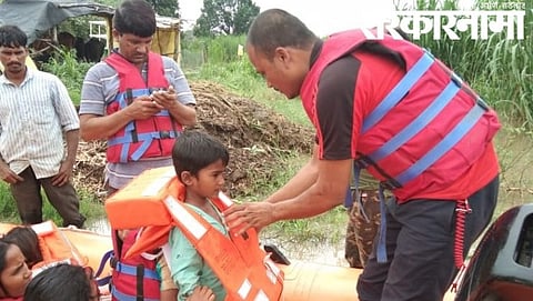 पुरात अडकलेल्या लहान मुलाला बोटीच्या साह्याने सुरक्षित स्थळी पोचवतांना एनडीआरएफचे जवान