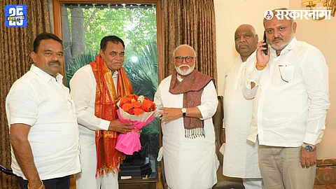 Newly elected Lasalgaon Market Committee chairman D.K. Jagtap receiving blessings from Chhagan Bhujbal
