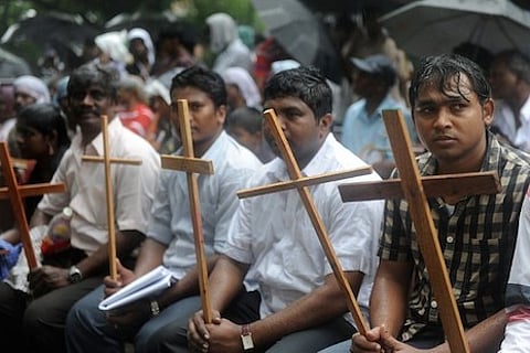 Indian Dalit - untouchable - Christians and Muslims sit in the rain during a protest rally against the National Commission for Scheduled Castes and Scheduled Tribes for its recent rejection of the demand for reservation for Dalit Christians and Muslims, in New Delhi on August 1, 2012.  Thousands of protestors, church leaders, nuns, bishops and priests of the National United Christian Forum demanded that the United Progressive Alliance (UPA) government grant equal rights and reservation for the Dalit Christians and Muslims.   AFP PHOTO/RAVEENDRAN