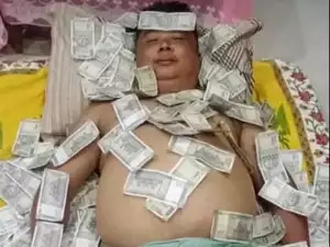 Assam: Pic Showing Former UPPL Member Sleeping On Stacks Of Rs 500 Notes Goes Viral