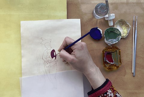 Demow girl Moyur Krishna Gogoi preparing miniature painting