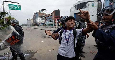 Police personnel trying to detain a protester in Nepal's Kathmandu on Monday during a protest against corruption and the government’s decision to block several social media platforms.