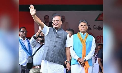 Assam Chief Minister Himanta Biswa Sarma waves to supporters during a campaign rally at Dimakuchi in Udalguri on Thursday