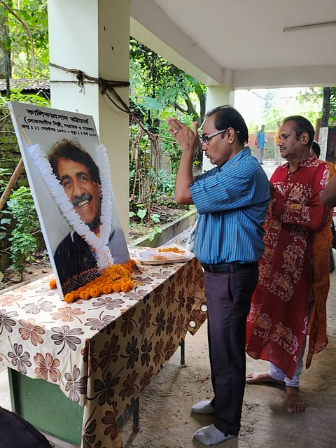 Floral tribute being paid to the legendary folk artist Kalika Prasad Bhattacharjee on his birth anniversary