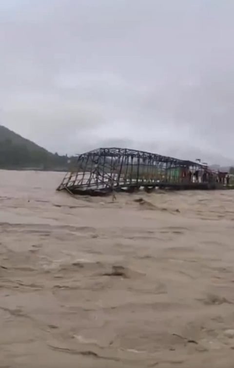 Image of Faonaba Unity Bridge Sweeping Away Over The Thoubal River Due to Heavy Flood in Manipur