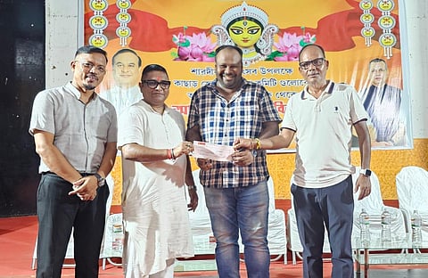 Cachar District Administration formally handing over demand drafts of government-sanctioned assistance of Rs 10000 each to 100 Durga Puja committees.
