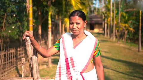 Image of a woman from Tinsukia, named Jinamoni Handique, Journey Shines Under Mission Basundhara 3.0, now, she proudly lives peacefully, without any legal claim to the land she called home