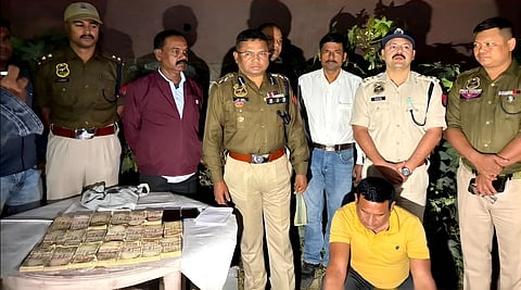 Image of the accused alongside the police officials