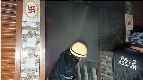 Image of a firefighter while trying to contain the blaze in the shops