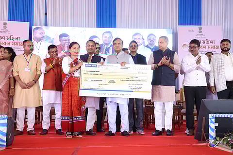 Image of Assam CM Himanta Biswa Sarma distributing cheques under the Mukhyamantri Mahila Udyamita Abhiyaan scheme in Hailakandi