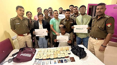 Image of the arrested individuals with the seized items on display