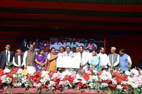 Image of Assam CM Himanta Biswa Sarma distributing the seed capital cheques to female beneficiaries in Lumding