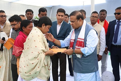 Image of Assam Chief Minister while distributing Rs 5 lakh cheques to the deceased families