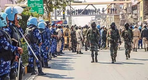Tensions soar and houses are set ablaze after a mother of five is fatally shot during protests over the arrest of village volunteers