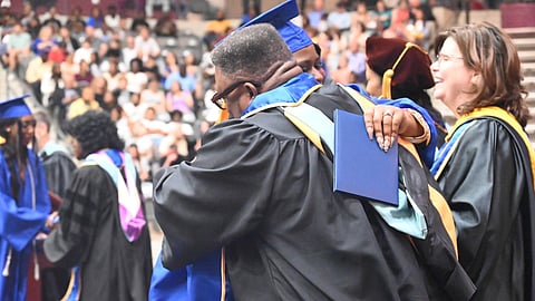 Sandy Williams, the director of the
North Little Rock Academy, celebrates with students on graduation day