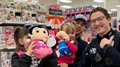 Zachary Logston and his two daughters participating in shop with a cop