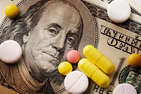 Medicine pills or capsules, vitamin with money, dollar. Medical or pharmacy prescription for health. Business, finance concept. Cost of the healthy life. Money and pharmacy still life.