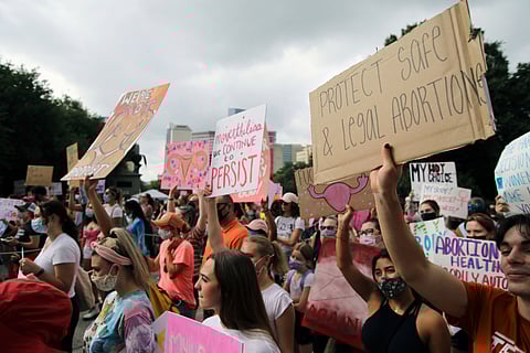 Austin, TX, USA - Oct. 2, 2021: Participants at the Women's March rally at the Capitol protest SB 8, Texas' abortion law that effectively bans abortions after six weeks of pregnancy.