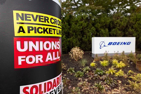 Union stickers cover a pole near the Renton Boeing facility as workers strike for better wages and their pensions back.