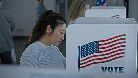 Multicultural American citizens come to voting booth in polling station office. National Election Day in the United States. Political races of presidential candidates. Civic duty, patriotism concept.
