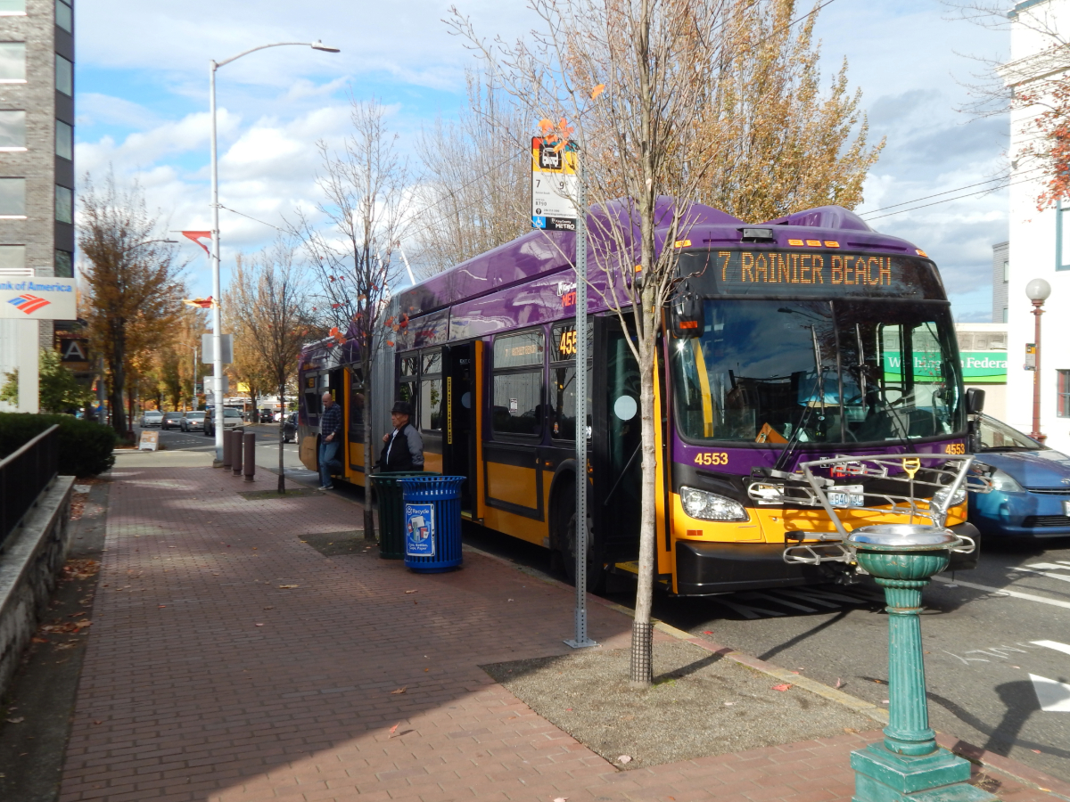 The No. 7 bus to Rainier Beach stops at an uncovered Columbia City stop outside a Bank of America.