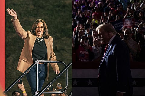 A split image showing two political figures at separate events. On the left, Kamala Harris wearing a tan blazer and black shirt waves and smiles warmly, lit brightly against a dark background. On the right, Donald Trump in a dark suit with a red tie stands in profile, looking downward, illuminated by low lighting, with a crowd of supporters holding up signs and phones behind him.