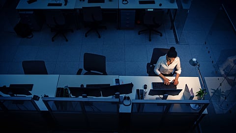 Alone Working Late at Night in the Office: Businesswoman Using Desktop Computer, Analyzing, Using Documents, Solving Problems, Finishing Project. High Angle Shot.