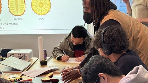 Marcus Henderson instructs students through a project.