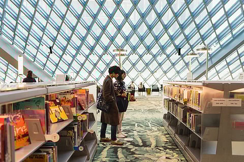 Patrons browsing the shelves at the Central Branch in downtown Seattle.