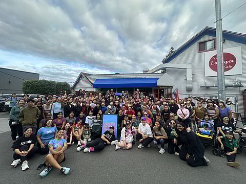 Seattle Latinas Run Club group photo in front of the Lockspot Cafe after Melt ICE run, showing diverse runners and supporters posing together on a cloudy day in Seattle.