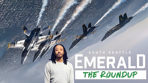 Aerial photo depicting the Blue Angels performing with exhaust over city landscape.