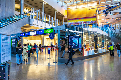 Passengers entering and leaving a security checkpoint at SeaTac airport