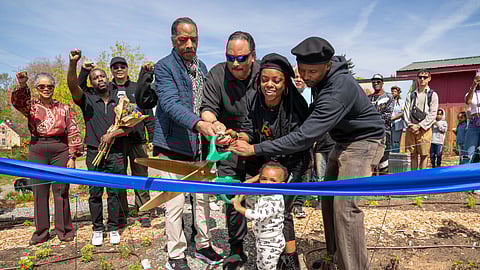 Aaron and Elmer Dixon and Nyema Clark cut a ribbon at the Black Panther Park opening in Skyway.