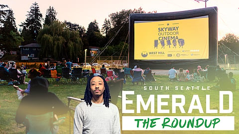 People sit outdoors looking at a large screen that reads "Skyway Outdoor Cinema." A photo of Mike Davis and the words "The Roundup" are overset across the bottom of the photo.
