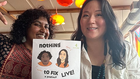 Jordan Alam and Gloria Huh smile with flyer.