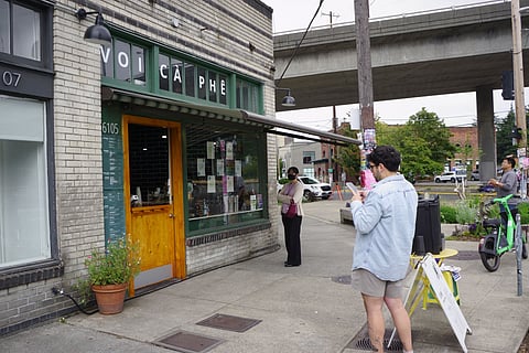 Customers standing outside Voi Ca Phe.