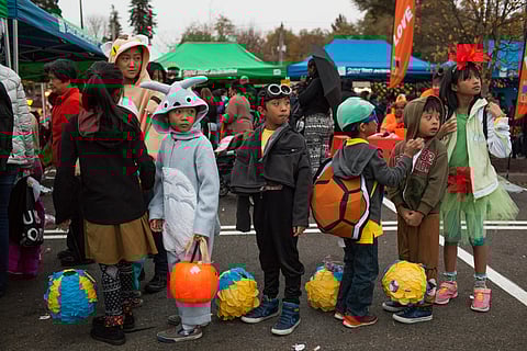 The Yangua and Salvador cousins wait in line for a game on Monday, October 31, 2016 at the Rainier Beach Boo Bash.