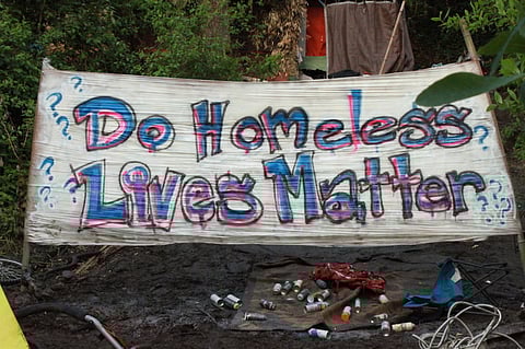 A banner made by activists hangs near an encampment in Ravenna in 2018. (Photo: Kelsey Hamlin)