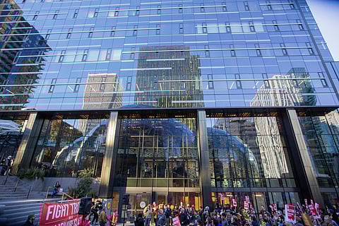 The Spheres are reflected above protestors, during the Tax Amazon protest at The Spheres in Seattle, Washington, on April 10, 2018. (Photo: Carolyn Bick)