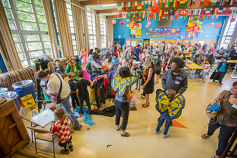 People try on costumes, during the Love Makes A Family event at Graham Hill Elementary School in Seattle, Washington, on June 7, 2018.