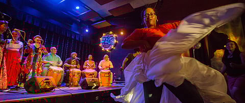 A member of Otoqui Reyes y Los Hijos de Agueyban, a Puerto Rican music and dance group, dances off-stage, during the Seattle Latin, Brazilian, and Caribbean Festival at the Royal Room in Seattle, Washington, on July 27, 2018. (Photo: Carolyn Bick)