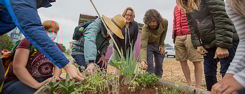Emily Scali, right, invites class participants to smell different herbs, during a class on permaculture at The Beet Box in Seattle, Washington, on Aug. 25, 3018. (Photo: Carolyn Bick)