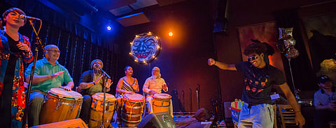 A young man dances to the music of Otoqui Reyes y Los Hijos de Agueyban, a Puerto Rican music and dance group, during the Seattle Latin, Brazilian, and Caribbean Festival at the Royal Room in Seattle, Washington, on July 27, 2018. (Photo: Carolyn Bick)